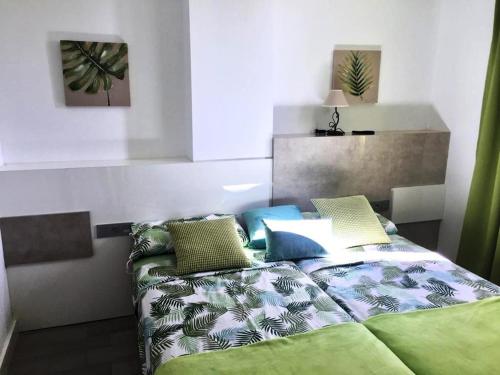 a bedroom with a bed with pillows on it at New apartment near the beach in Playa Paraiso in Playa Paraiso