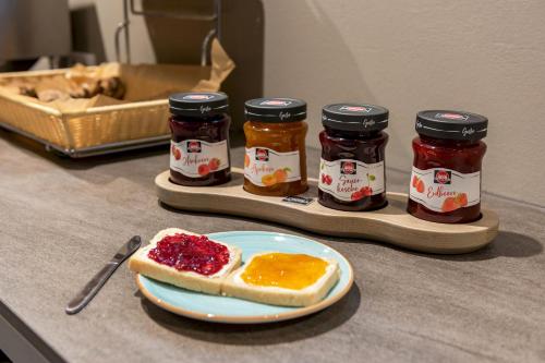 a table with a plate of jam and a piece of bread at a&o Copenhagen Sydhavn in Copenhagen