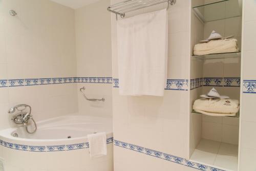 a bathroom with a tub and a shower at TRH Mijas in Mijas