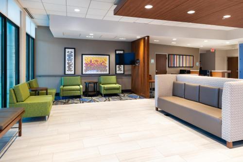 a waiting room at a hospital with green chairs at Holiday Inn Express & Suites - Romeoville - Joliet North, an IHG Hotel in Romeoville
