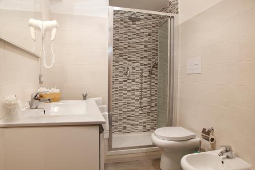 a bathroom with a sink and a toilet and a shower at Hotel San Germano in Piedimonte San Germano