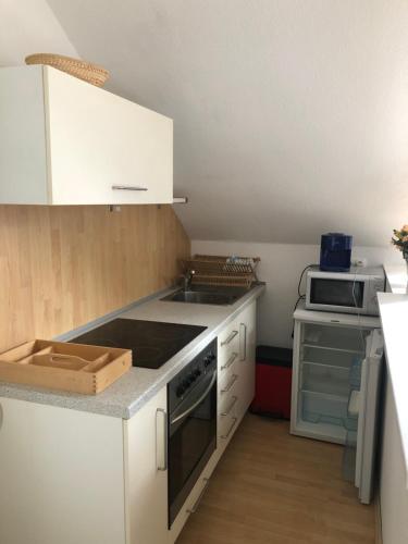 a kitchen with a sink and a stove top oven at 45 m² Maisonette-Wohnung in Uni-/Hauptbahnhofnähe in Duisburg