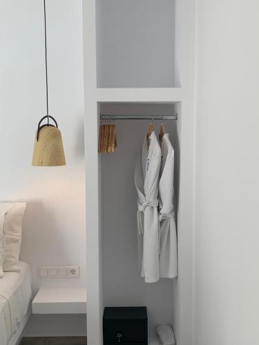 a room with white clothes hanging in a closet at Chill Out Studio in Mýkonos City