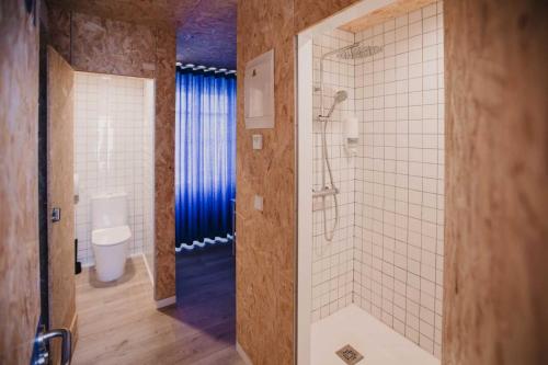 a bathroom with a shower and a toilet at SubUp Hostel in Cabo de Palos