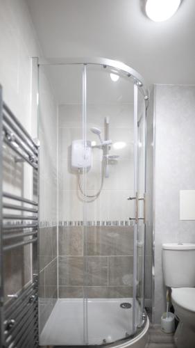 a bathroom with a shower and a toilet at City Lodge Serviced Apartments Worcester City Centre - Parking in Worcester