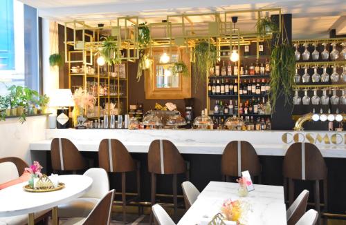 a restaurant with two tables and a bar at Hôtel Cosmopolitain in Biarritz