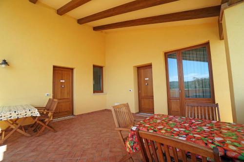 a dining room with a table and chairs and a window at Cascina al Colle in Populonia