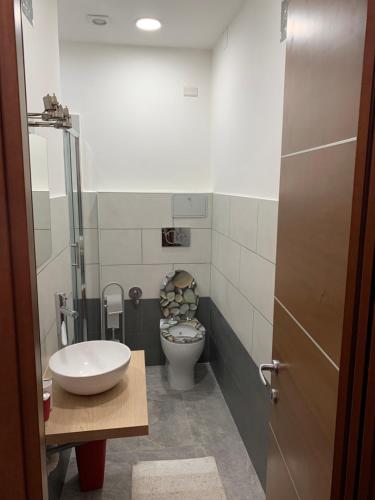 a bathroom with a toilet and a sink at Appartamento di Paolo Unicusano in Rome