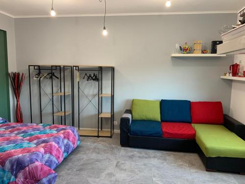 a room with a colorful couch and a bed at Appartamento di Paolo Unicusano in Rome