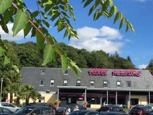 a building with pink writing on the top of it at Acanthe hotel in Erbrée