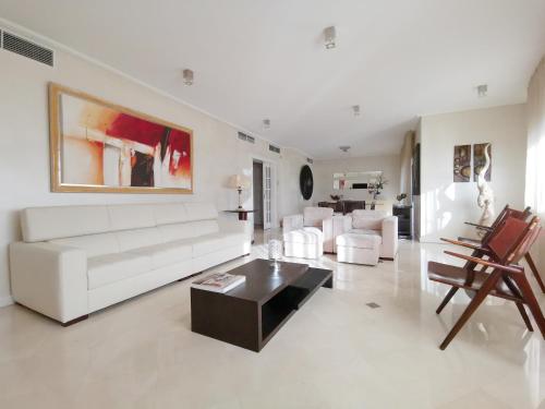 a living room with a white couch and a table at Entire floor parque nacoes prime apartments expo30 in Lisbon