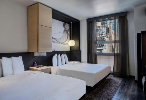 a hotel room with a bed and a television at Hyatt Herald Square New York in New York