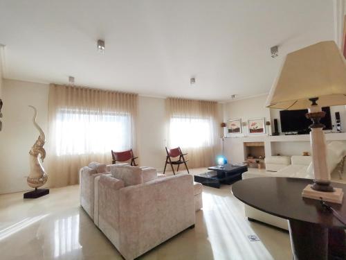 a living room with a couch and a table at Entire floor parque nacoes prime apartments expo30 in Lisbon
