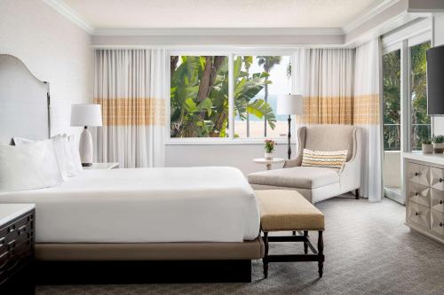 a hotel room with a bed and a chair at Hyatt Regency Huntington Beach Resort and Spa in Huntington Beach