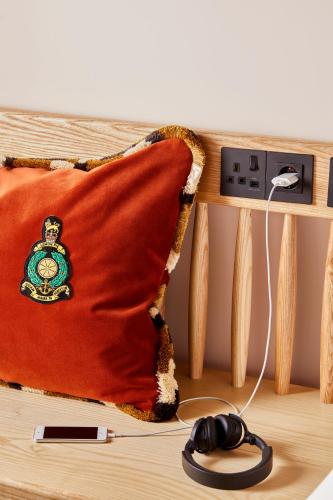 a red pillow on a table with a mouse at Mama Shelter London - Shoreditch in London