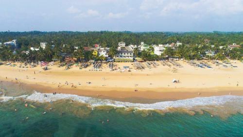 an aerial view of a beach with a group of people at Ritas Hotel in Hikkaduwa