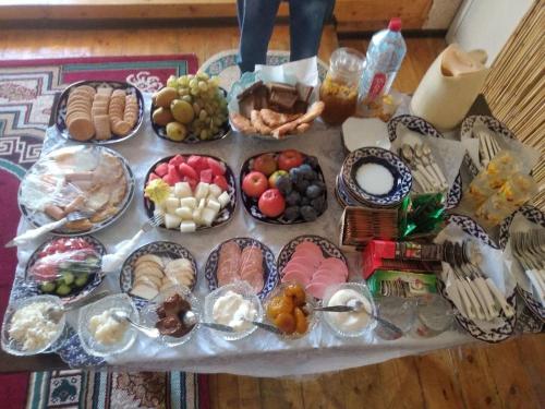 a table topped with lots of different types of food at Yulduz Hotel in Khiva