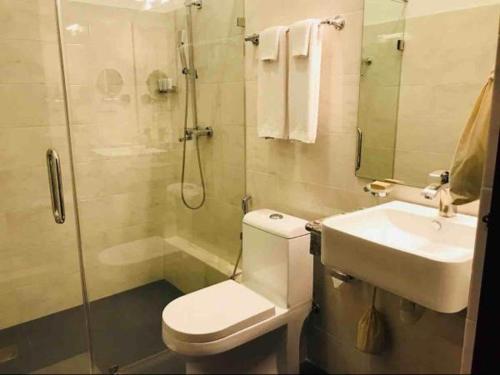 a bathroom with a toilet and a sink and a shower at Morven Hotel Colombo in Colombo