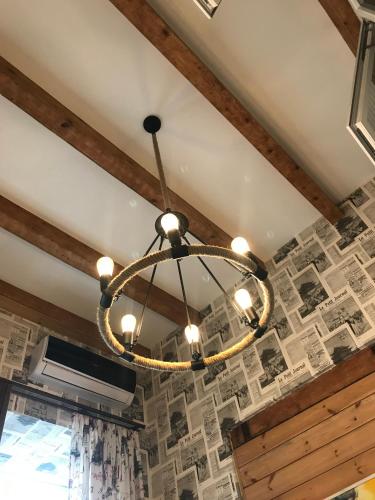 a chandelier in a room with a brick wall at Le Petit in Tbilisi City