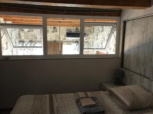 a bedroom with a bed and a window at Le Petit in Tbilisi City