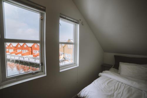 a bedroom with a window with a view of a building at Fab scenery in Ballstad
