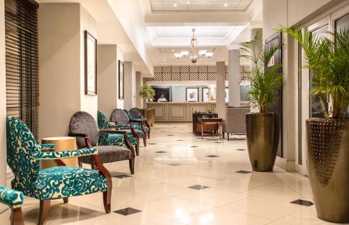 a waiting area in a hospital with chairs and tables at Southern Sun Ridgeway Lusaka in Lusaka