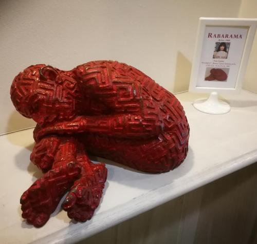 a red sculpture of a turtle sitting on a table at Eco Art Hotel Statuto in Turin