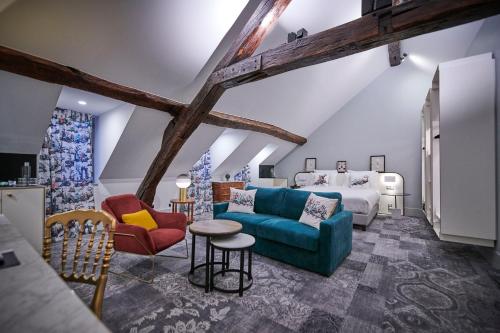 a living room with a bed and a blue couch at Normandy Le Chantier in Paris