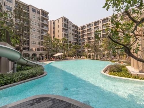a large swimming pool in a city with tall buildings at La casita Hua-Hin seaview by Yaya in Hua Hin