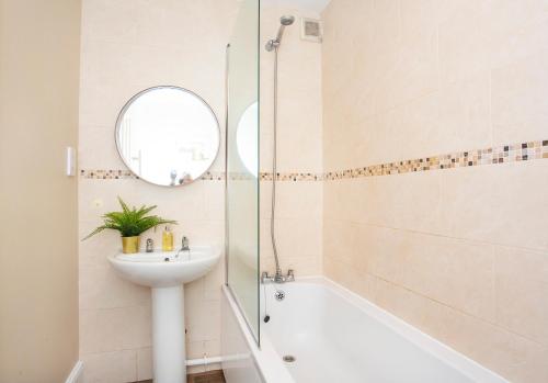 a white bathroom with a sink and a shower at Knavesmire Mews 3 bedrooms-Free parking in York
