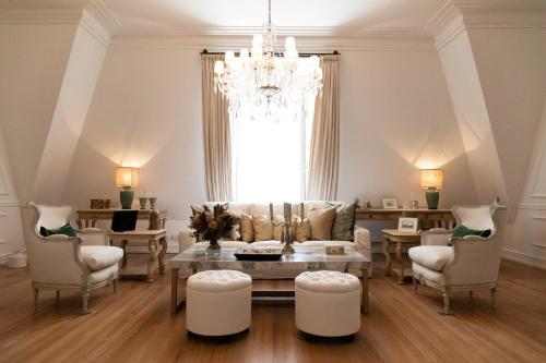 a living room with a couch and a table and chairs at Four Seasons Hotel Buenos Aires in Buenos Aires