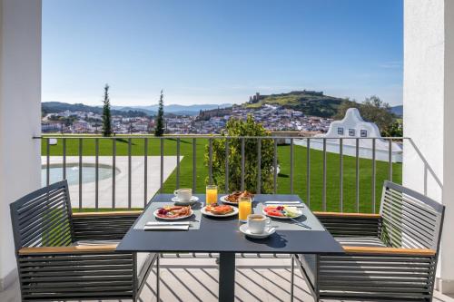 a table with plates of food on a balcony at Barceló Aracena & Spa in Aracena