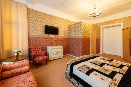 a bedroom with a bed and a table and a chair at Hotel Pension Dahlem in Berlin