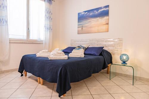 a bedroom with a bed with towels on it at Baia Blu RTA Residence in Lerici