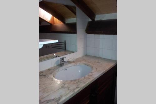 a bathroom sink with a marble counter top at Beach House - Tavira Island in Tavira