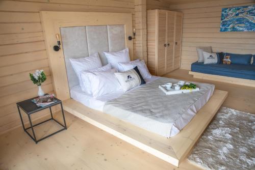 a small room with a bed and a table at Шале Рутенія - Chalet Rutenia apartments in Neporotovo