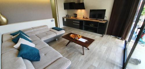 a living room with a couch and a table at Villa Adler Men Only in Playa del Ingles