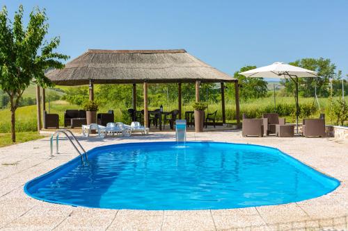 a large swimming pool with a gazebo at Agriturismo Molino Nuovo in Castel San Pietro Terme