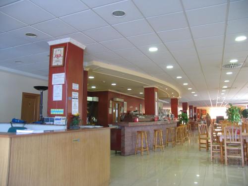un restaurante con bar y algunos taburetes en un edificio en Hostal Imperial en Crevillente