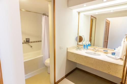 a bathroom with a sink and a mirror at Sonesta Hotel Cali in Cali