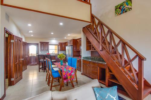 a kitchen with a table with blue chairs and a staircase at Seiri del Mar in Hopkins