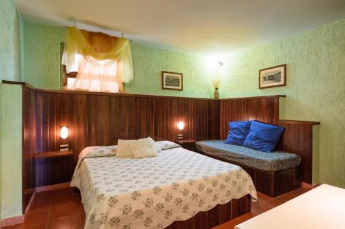 a bedroom with two beds and a window at Residence Casa Lama in Castelfranco di Sopra