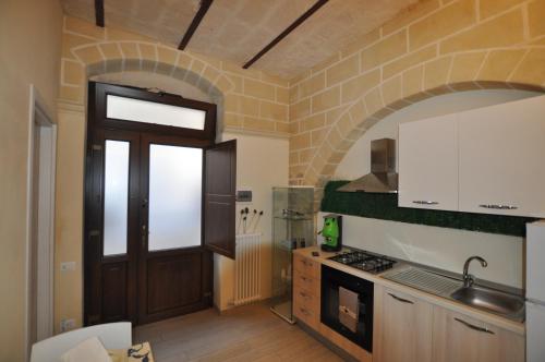 a kitchen with a door and a stove top oven at Le dimore della Luna in Matera