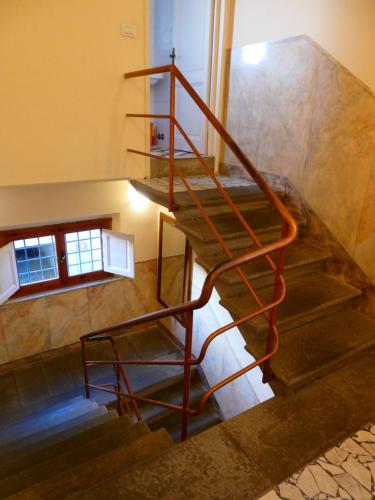 a spiral staircase in a building with a metal railing at Casa storica e confortevole in Empoli