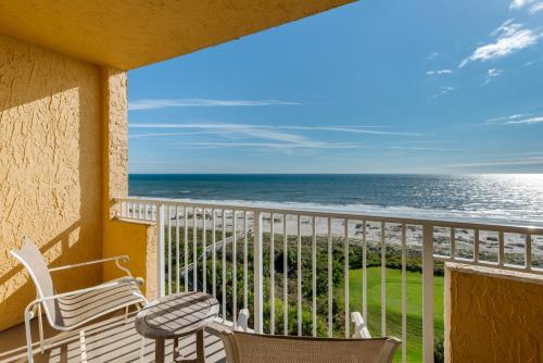 a balcony with chairs and a view of the ocean at Omni Amelia Island Resort in Amelia Island