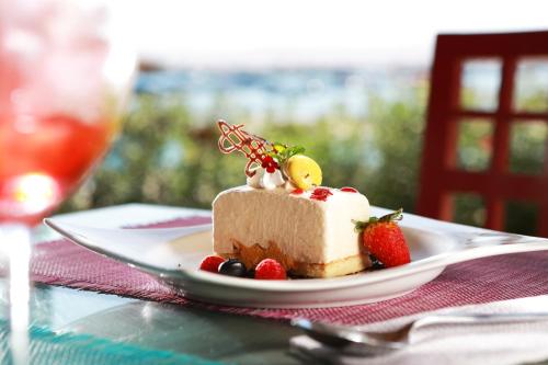 a piece of cake with strawberries on a plate on a table at San Agustin Paracas in Paracas