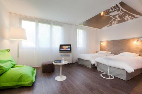 ibis Styles Lille Aéroport tesisinde bir odada yatak veya yataklar