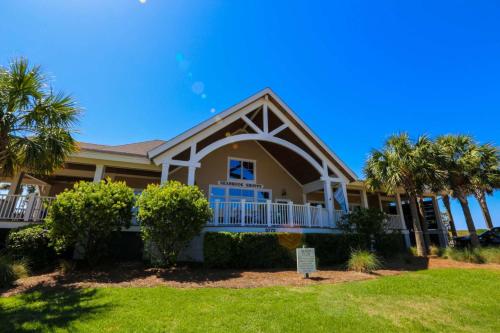 a house with palm trees in front of it at Rue De Buci in Johns Island