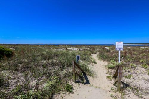 a beach with a sign in the sand at Rue De Buci in Johns Island