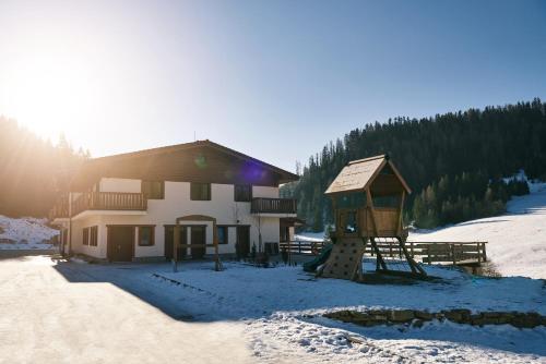 a ski lodge with a playground in the snow at Hotel Studničky in Vernár
